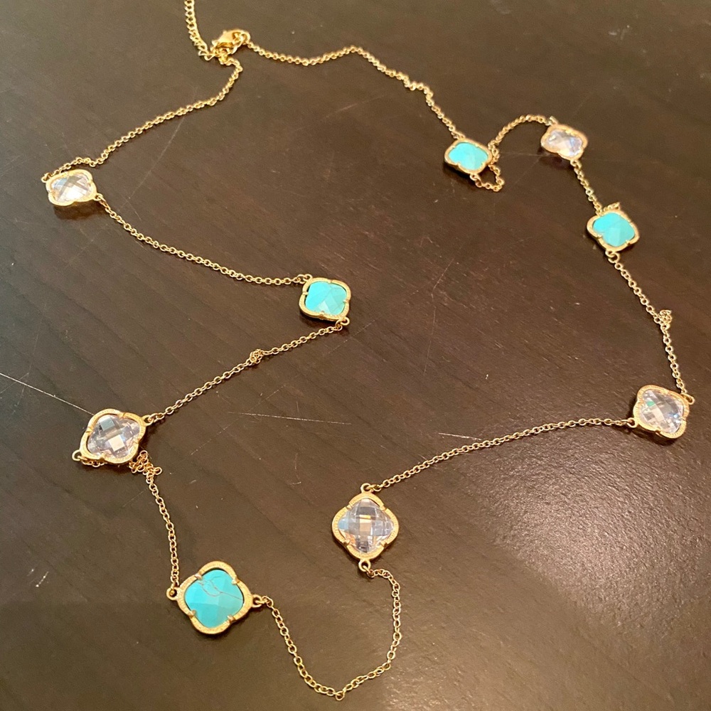 Long gold necklace with clear and teal stones